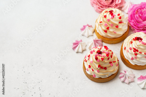 Mother's day holiday brunch with cupcake craem and pink flowers on white background
