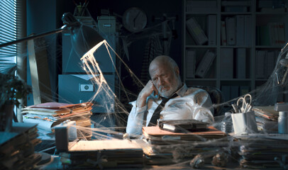 Desperate businessman sitting in his abandoned office