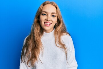 Beautiful blonde caucasian woman wearing casual winter sweater with a happy and cool smile on face. lucky person.