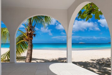 Tropical beach resort with palm trees, white sand and Caribbean sea. Summer vacation and tropical...