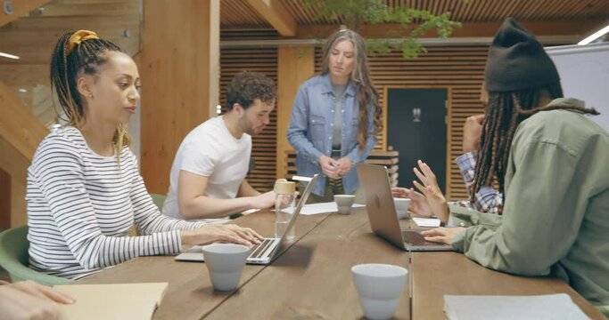 Diverse businesspeople working 
around an office table
