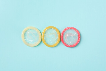 Flat lay colorful condoms isolated on blue background