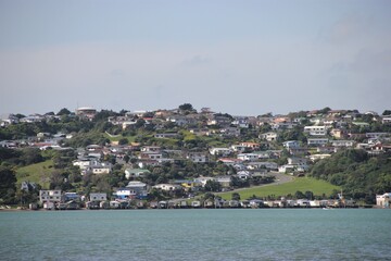 The Eastern side of the Porirua suburb of Titahi Bay, a traditional New Zealand suburb made up of a wild and colorful variety of detached homes along the emerald waters of Porirua Harbour