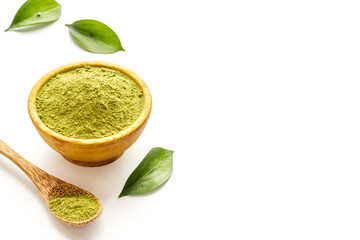 Henna powder in wooden bowl with green leaves. Herbal natural hair dye