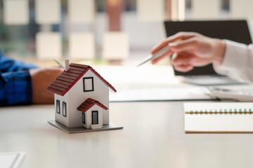 Buying a Home or Insurance, an insurance agent explains the lease agreement to a client before...