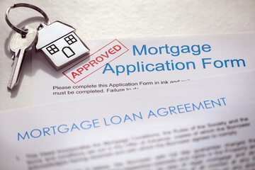Mortgage application form and loan agreement with house key