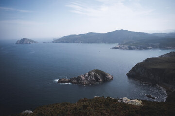 small island near a coast with cliffs