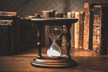 Hourglass and collection of old books