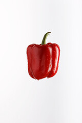 Juicy red bell pepper in spray of water. Freshpepper with splash on white background.