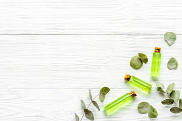 Herbal essence oil and eucalyptus leaves, top view
