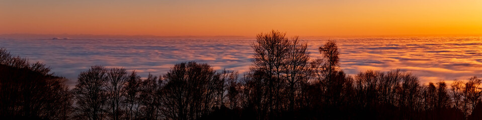Fototapeta premium High resolution stitched panorama of a beautiful sunset above the clouds at the famous Grandsberg, Bavarian forest, Bavaria, Germany
