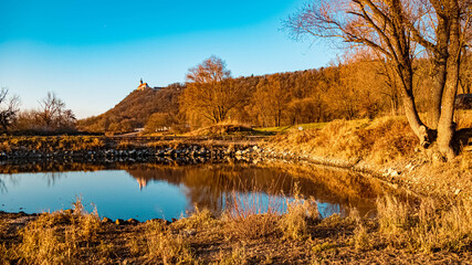 Fototapeta premium Beautiful autumn or indian summer view with reflections at the famous Bogenberg, Danube, Bavaria, Germany