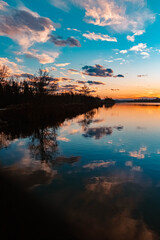 Beautiful sunset with reflections and dramatic clouds near Plattling, Isar, Bavaria, Germany