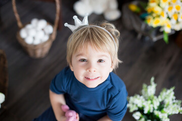 Beaufitlu toddler blond boy, wearing little crown, pretending to be prince