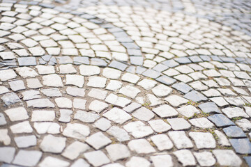 old style stone paving stones, old square stone tiles on the road and sidewalks, stone dirt road in the old town, laying slabs on the roads