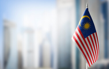 A small flag of Malaysia on the background of a blurred background