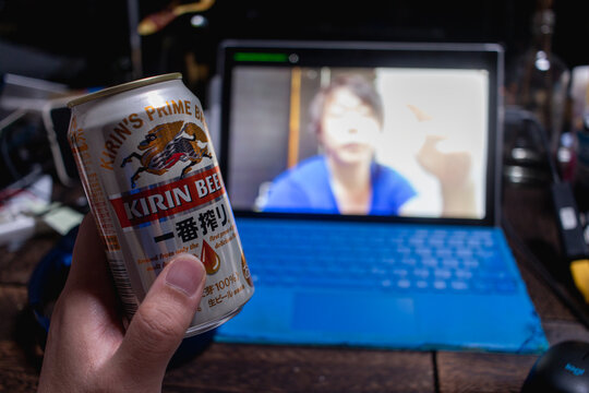 キリンの缶ビール 一番搾りを飲みながらパソコン越しの友人と会話。オンライン飲み会/自宅飲み/家飲み。コロナ禍で変わる日常。ニューノーマル。2021年3月撮影/日本