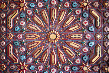 Close up of colored ornament on wood in traditional islamic style.