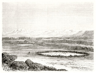 Gold and Silver round lakes viewed from distance on a huge rocky flatland, Peru. Ancient grey tone etching style art by Riou, Le Tour du Monde, 1862