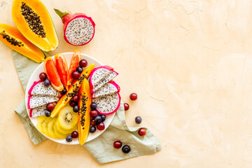 Tropical fruits salad with papaya and dragon fruit. Colorful exotic fruits