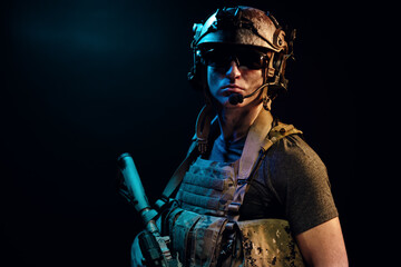 Special forces soldier with rifle on black background