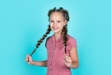 happy girl has beautiful hairstyle. kid with braided hair. child with nice smile. female hairdresser salon. beauty and fashion. childhood happiness. looking stylish and trendy