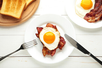 Eggs and bacon for breakfast on white background. English breakfast with copy space for text