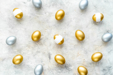 Happy Easter card with golden and silver eggs, top view