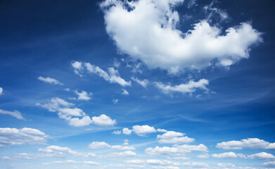 Naklejka na ściany i meble Azure sky background with white fluffy clouds in the fresh sunny day.