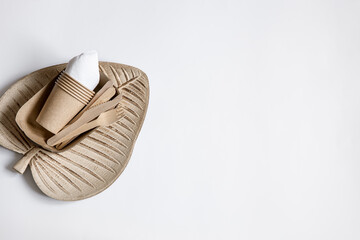 Composition with a set of disposable paper dishes and a ceramic plate top view.