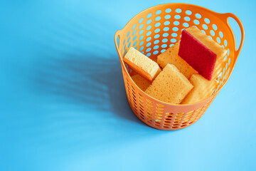 Close up of a basket with bright sponges for cleaning and keeping clean.