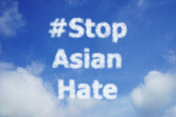 Naklejka na ściany i meble #Stop Asian Hate, white cloud text, on bright blue sky , campaign concept