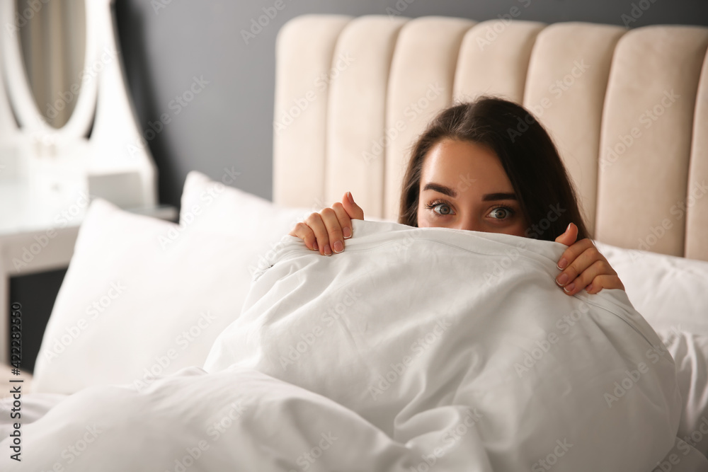 Canvas Prints Beautiful young woman wrapped with soft blanket relaxing on bed at home