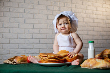 Little chef. Little kid dressed as a chef with pastries, buns, bread