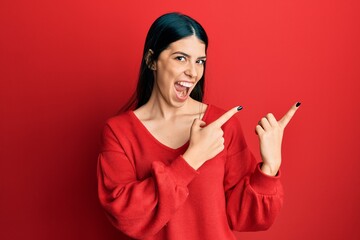 Fototapeta premium Young hispanic woman wearing casual clothes smiling and looking at the camera pointing with two hands and fingers to the side.