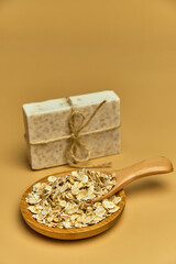 Handmade bath oat soap on beige background.