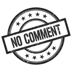 NO COMMENT text written on black vintage round stamp.