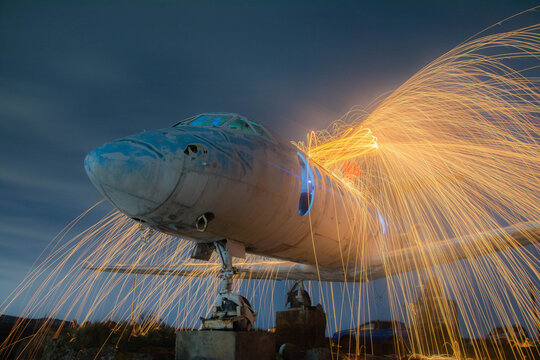 Burning airplane. The plane is on fire. Old plane. Fireworks on an abandoned plane. Fire show on the plane. Airplane photos and images
