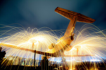 The plane is on fire. Fire show on an old plane. Fireworks on an abandoned plane. Burning airplane. Plane photos and images.