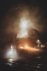 Road work at night.  Abstract photography with smoke and film grain effect
