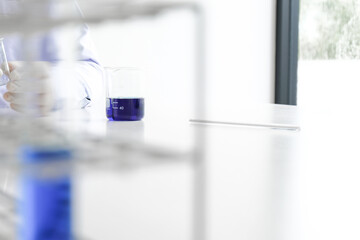 Science innovative Male medical or scientific laboratory researcher performs tests with blue liquid in laboratory. equipment science experiments technology Coronavirus Covid-19 vaccine research