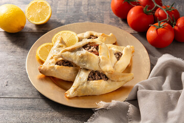 Traditional middle eastern fatayer on wooden table	