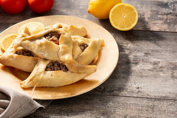 Traditional middle eastern fatayer on wooden table. Copy space