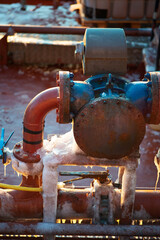 Old industrial pipes covered in ice
