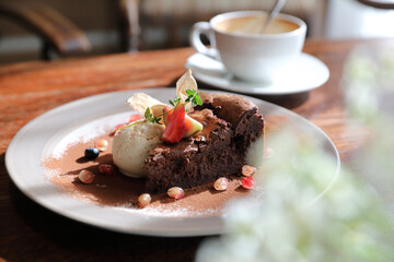 Chocolate cake with ice cream and coffee dessert on wood table