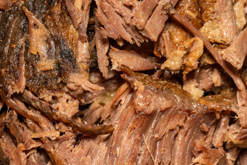 Slow cooked shredded pulled beef close up background viewed from above, stock photo image