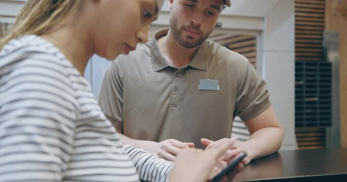 Businesswoman signing for a 
courier package in an office
