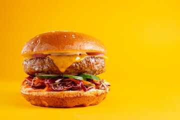 Delicious burger isolated on yellow background. Tasty fresh unhealthy hamburgers with cheese. Horizontal banner