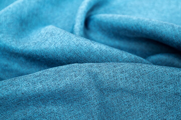 Blue fabric texture close up , focus only one point , soft blurred background wallpaper. Rough fabric texture, textile industry background with blurred. Colored cotton cloth. Abstract background