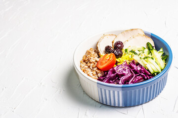 Buddha Bowl with buckwheat, baked lean pork, red cabbage, cucumber, tomato, olives, flax seeds